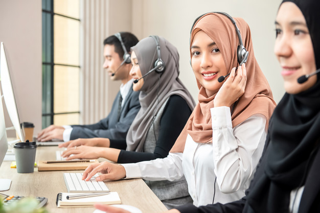 beautiful-asian-muslim-woman-working-call-center-with-team_8087-2054